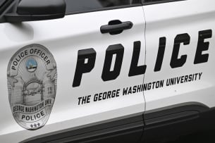 A photo of a police car reading "police—the George Washington University" on its side