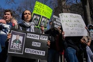 Demonstrators hold signs with photos of Mahmoud Khalil that say "Free Mahmoud, free Palestine"