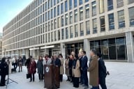 Lawmakers stand at a podium outside the Education Department building